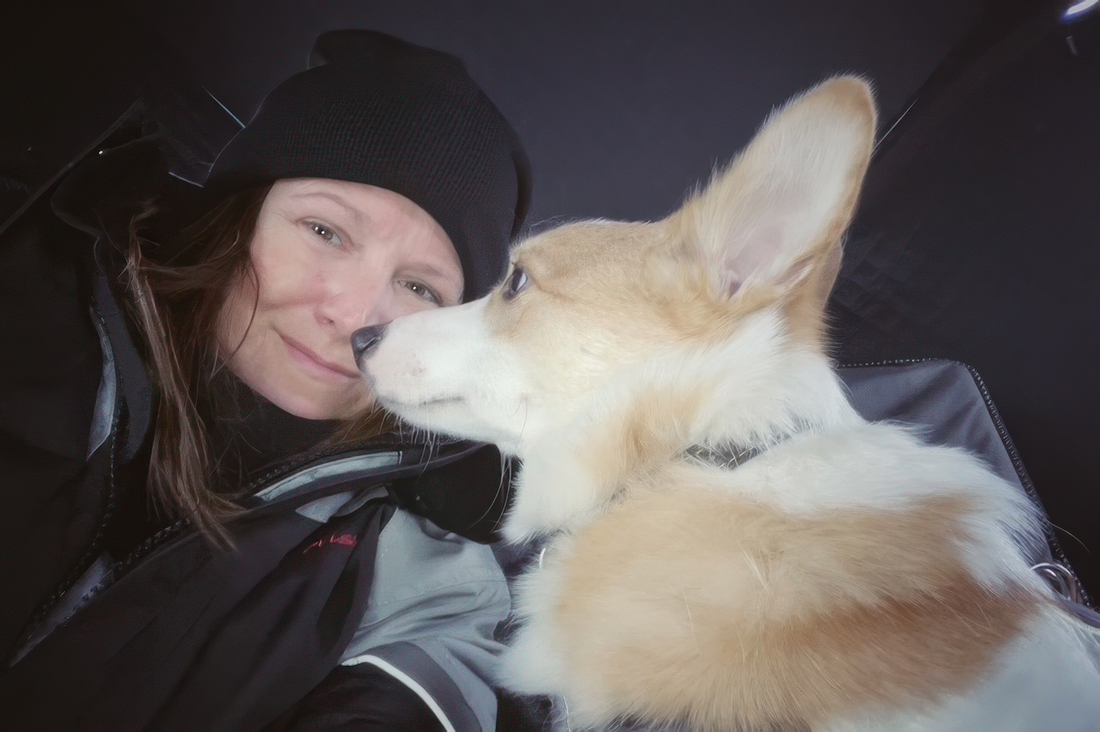 Terri, the maker behind Northern Simplicities, cheek-to-cheek with her corgi Smalls on a snowy day.